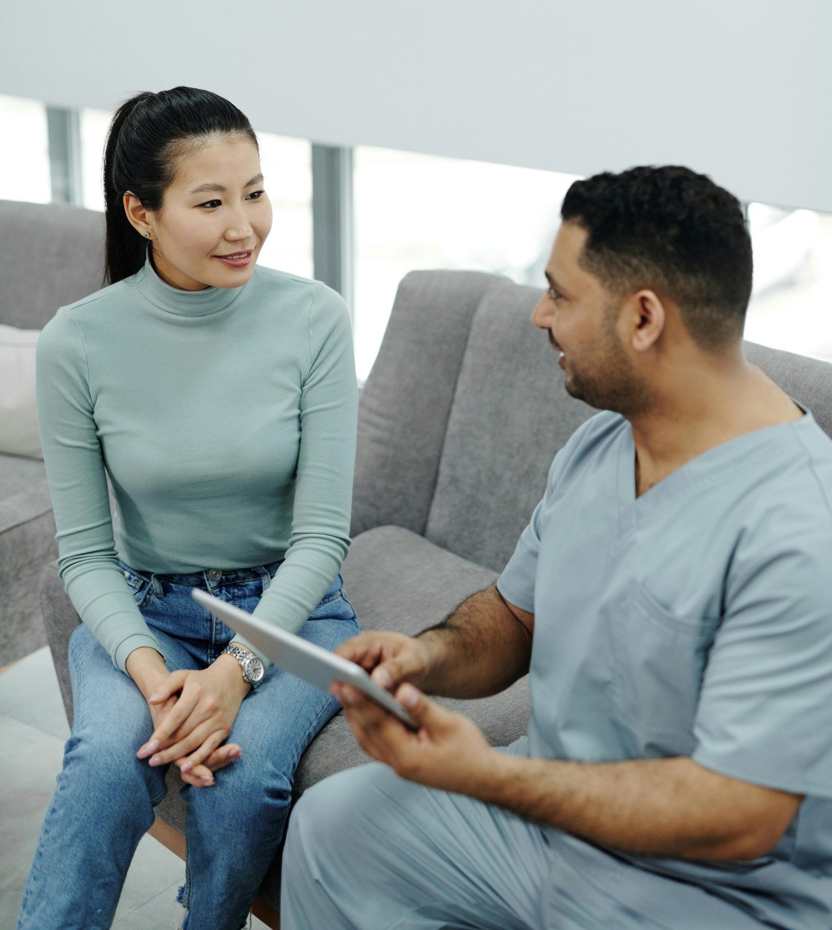 image A physiotherapist assisting a patient with stretching exercises indoors.